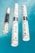 Three bottles of beauty products with silver accents are arranged on a bright blue background. The labels read 'lift hair' with various product names including shampoo and soin. The overall design is clean and modern.