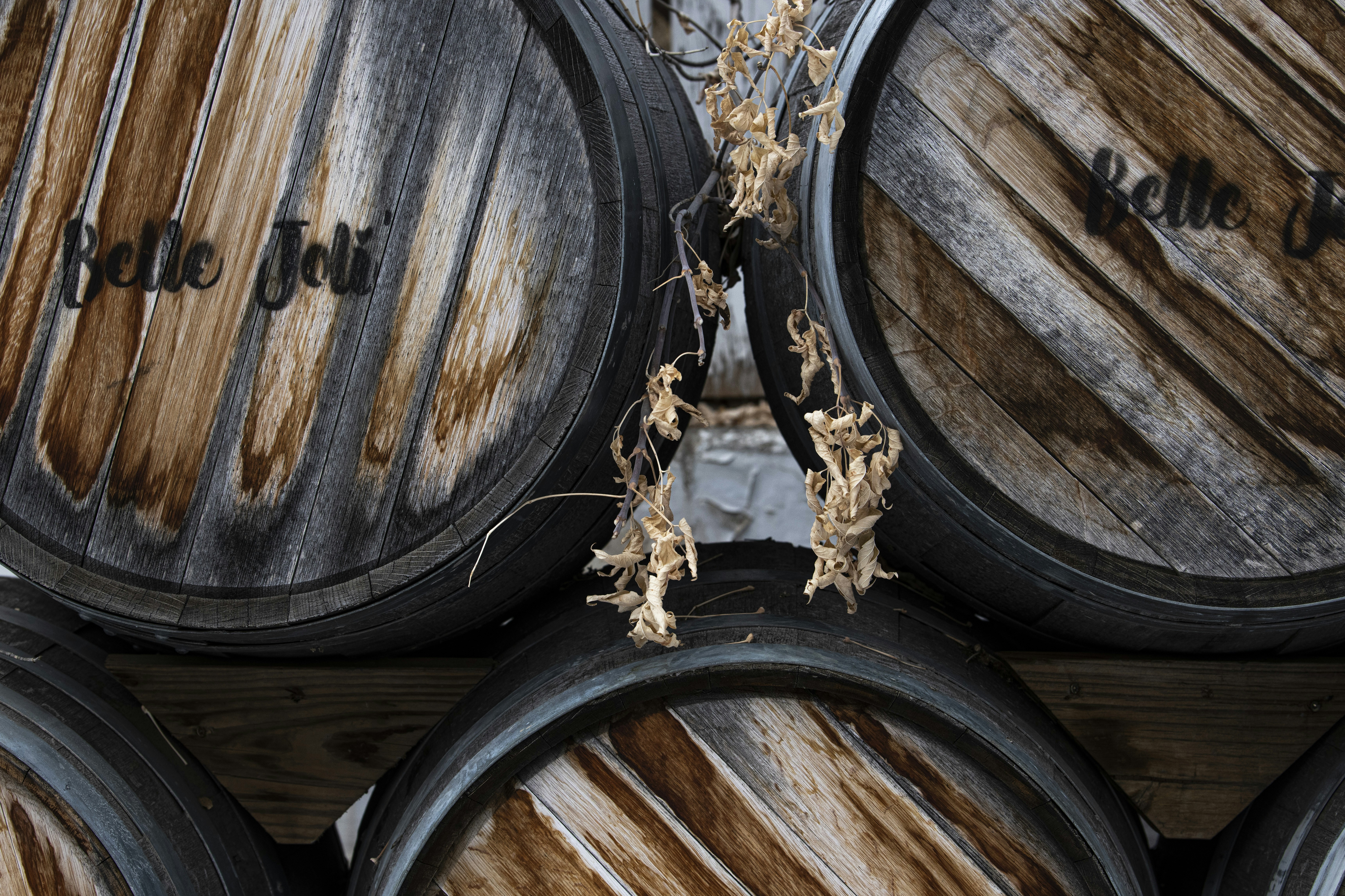 a bunch of wine barrels stacked on top of each other