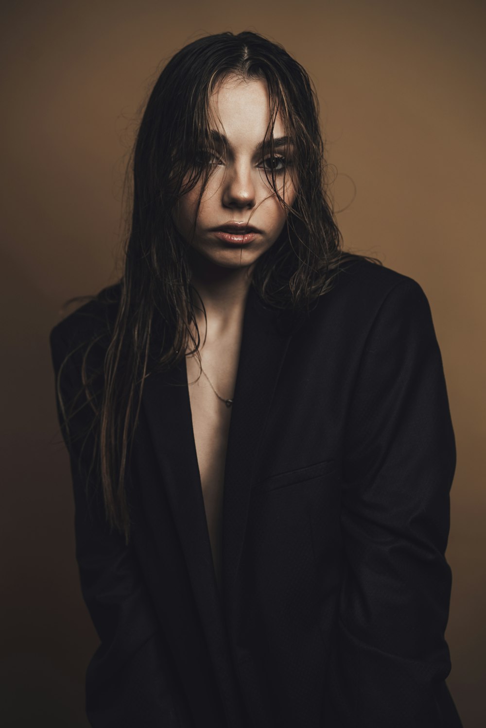 a woman with long hair wearing a black jacket