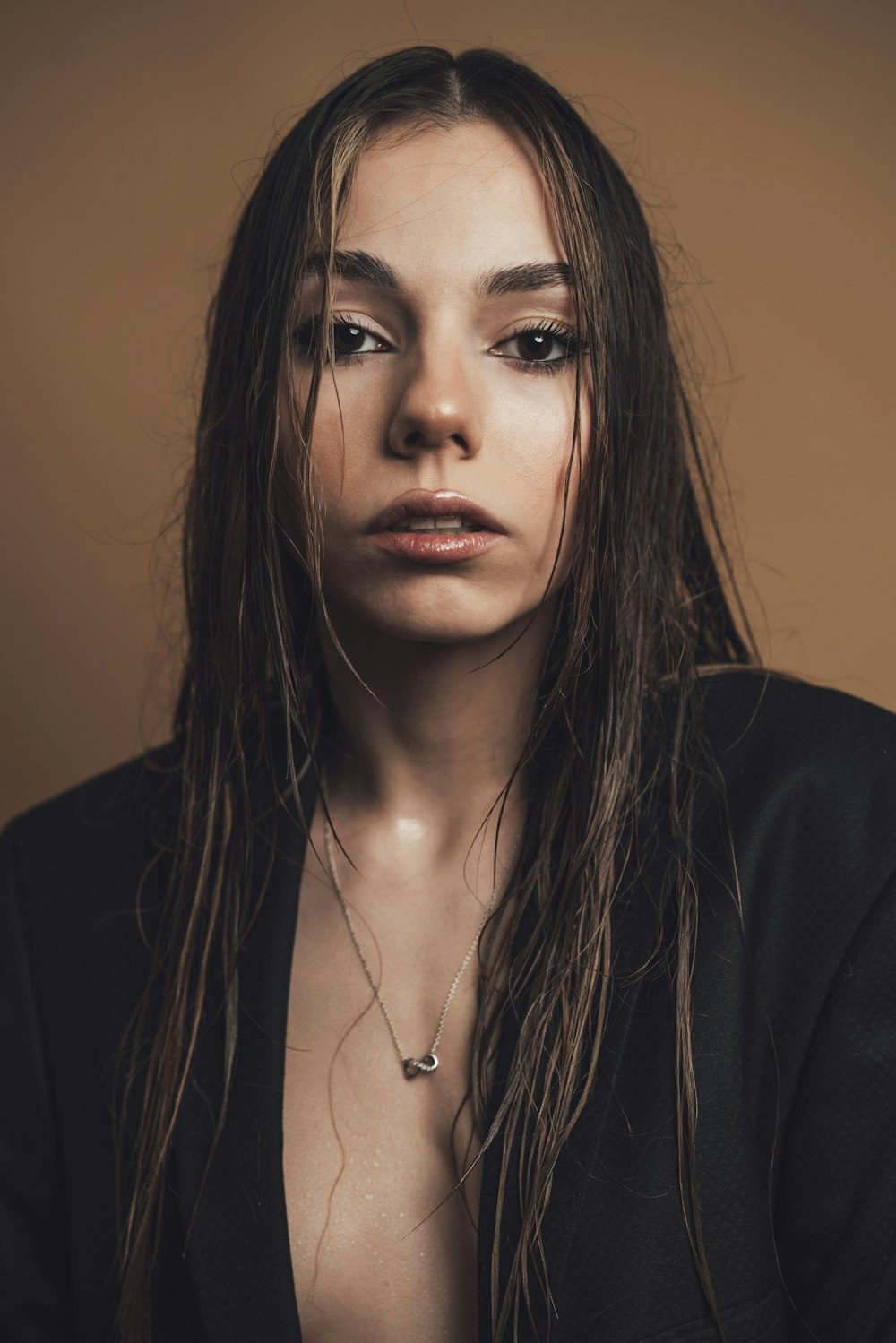 a woman with long hair wearing a black jacket