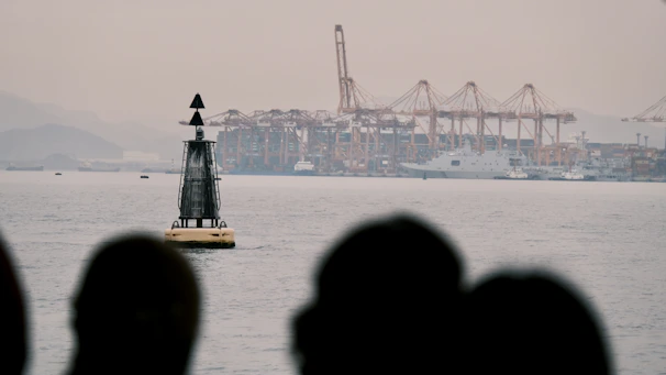 A group of participants attentively observing port operations during a guided tour.