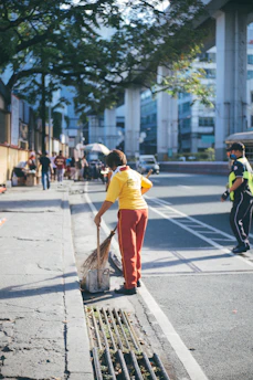 A vibrant street sweeper in action on a sunny urban street, showcasing Soldplast's equipment.