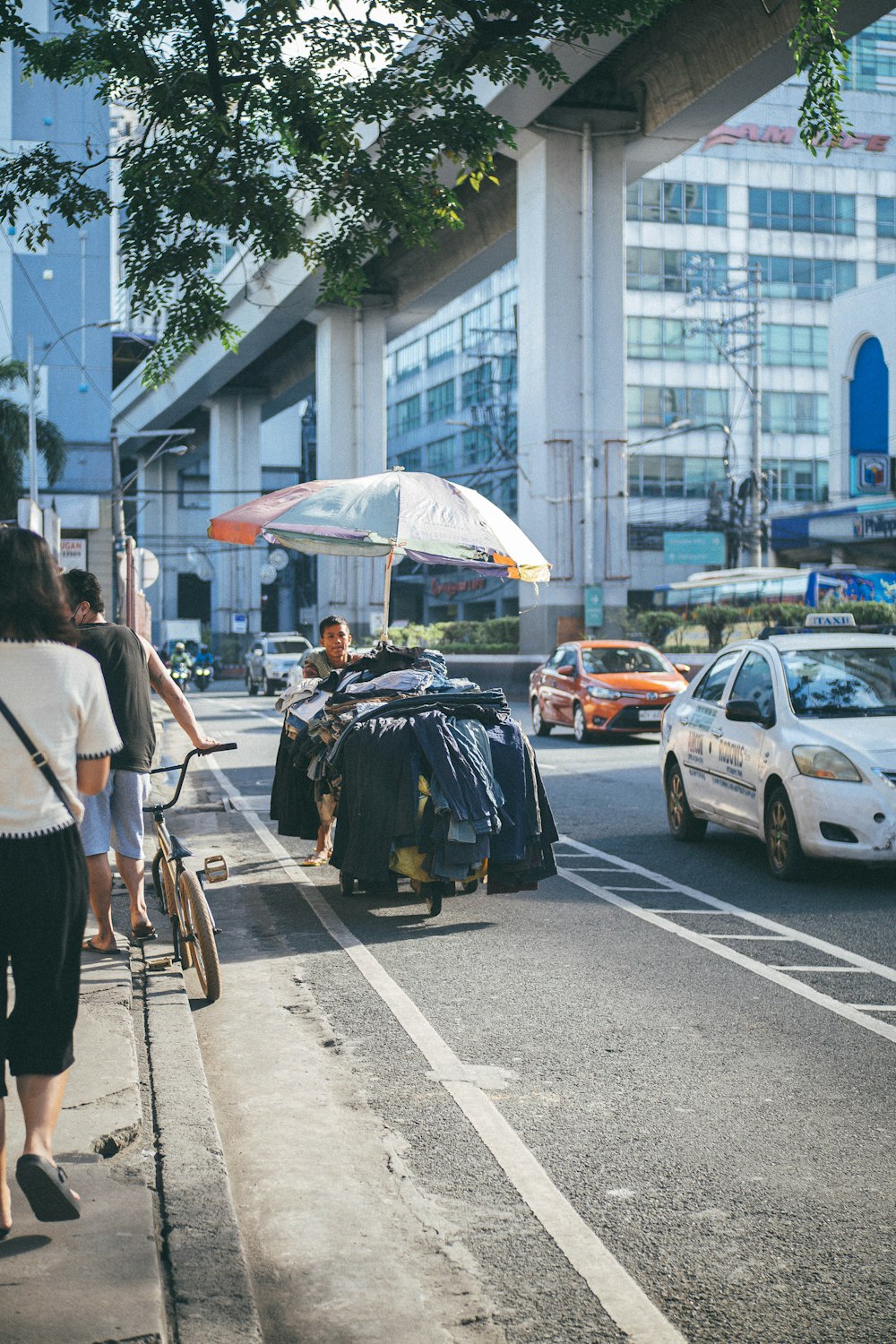 a group of people standing on the side of a road