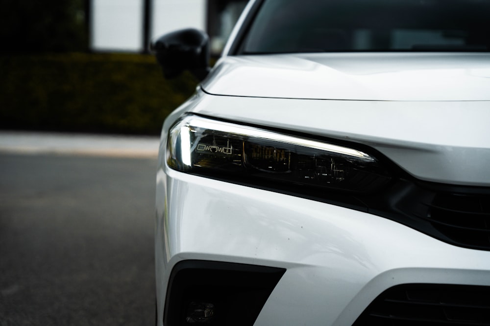 a close up of the front of a white car