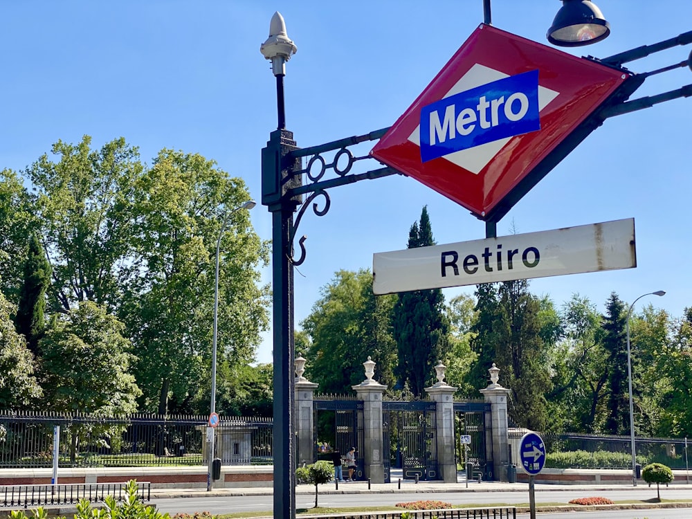 Un letrero de metro colgando del costado de un poste de metal