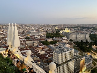Rooftop terrace with panoramic views of Abu Dhabi skyline at dusk.