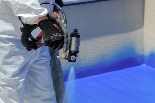 painting a wall with blue paint