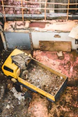 Workers loading debris into a 20-yard dumpster at a home remodeling project.