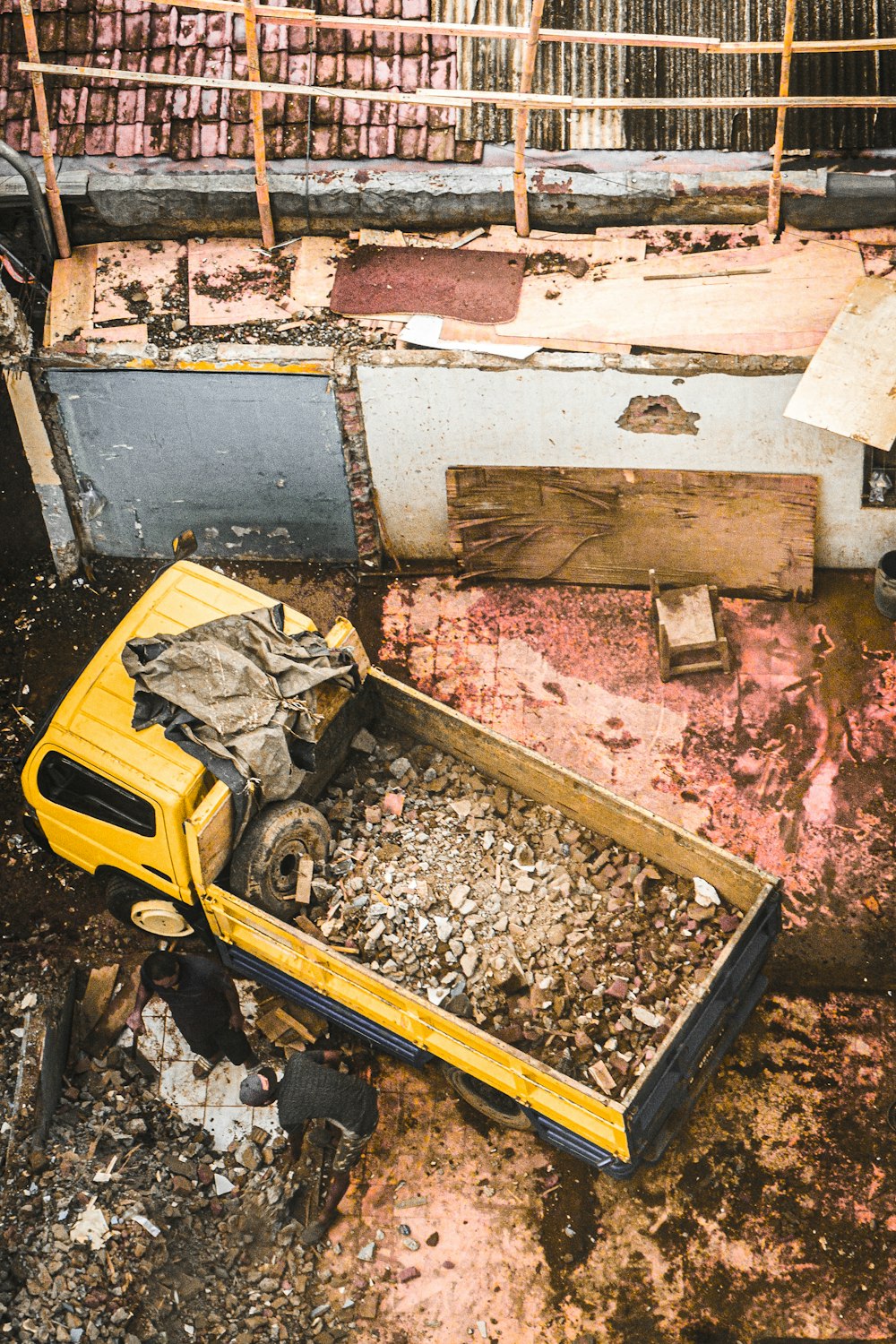 a yellow truck that is sitting in the dirt