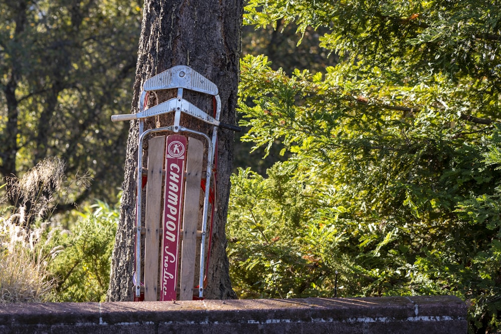 a sign that is next to a tree