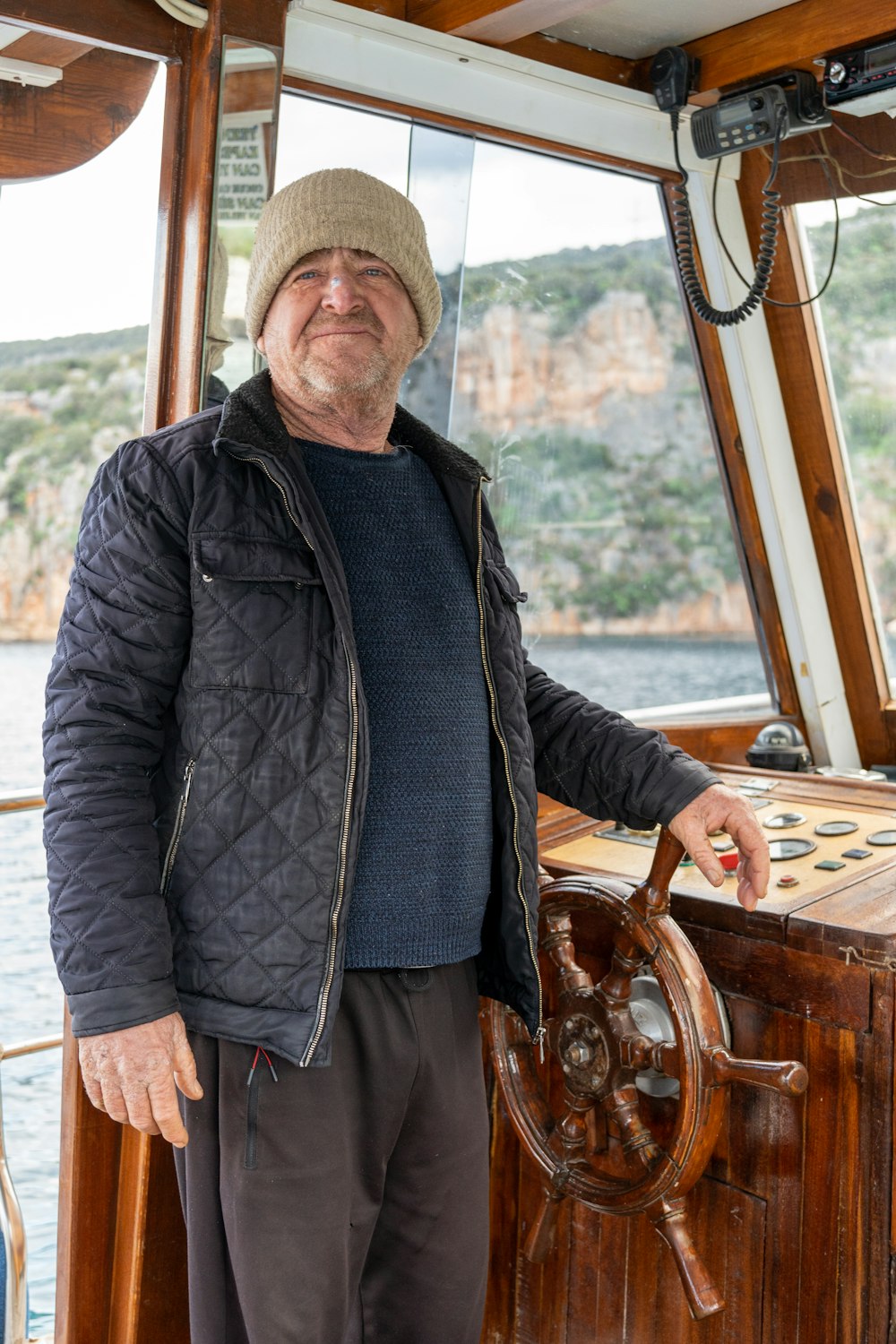 a man standing at the helm of a boat