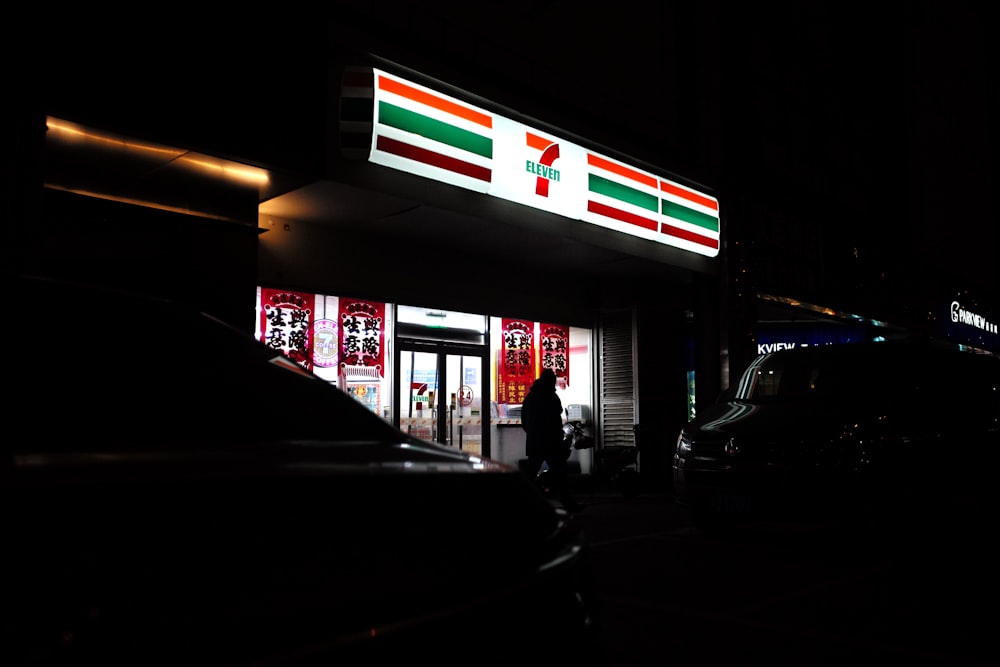 a person standing outside of a building at night