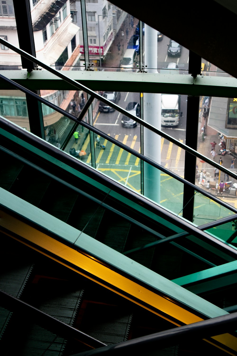 an escalator with a view of a street below