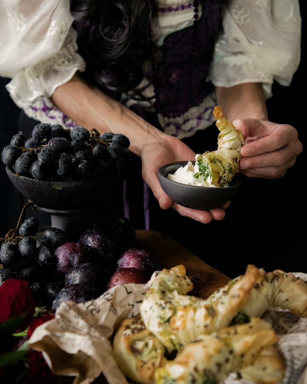 a woman is holding a bowl of food