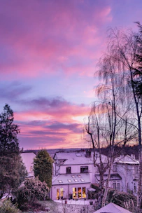 A calm suburban home bathed in soft morning light, symbolizing hope and stability.