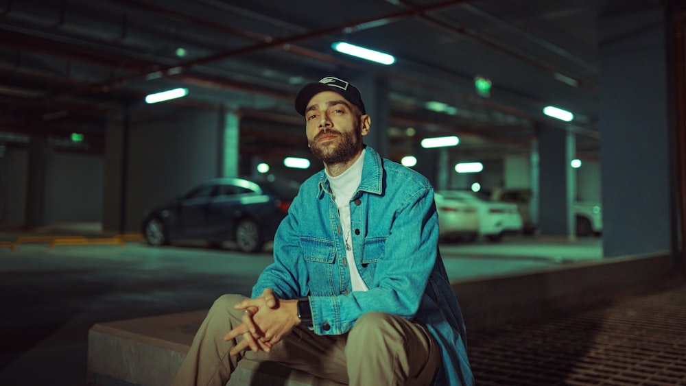 a man sitting on a bench in a parking garage