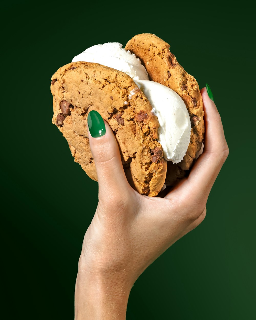 una persona che tiene un biscotto con marshmallow in cima