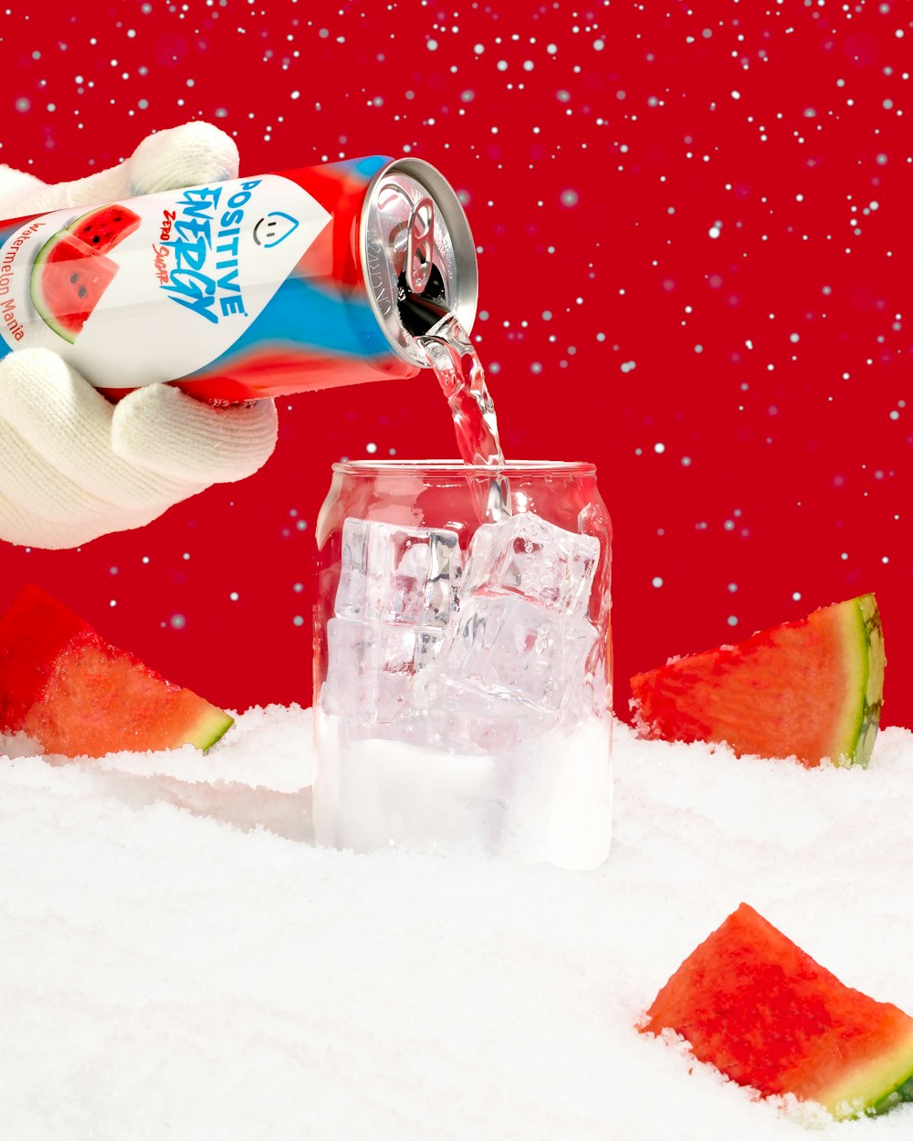 a hand is pouring water into a glass of watermelon