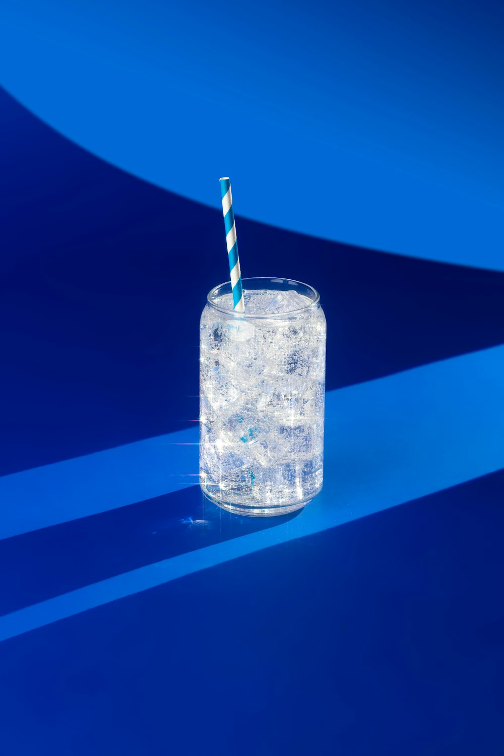 a glass filled with ice and a straw