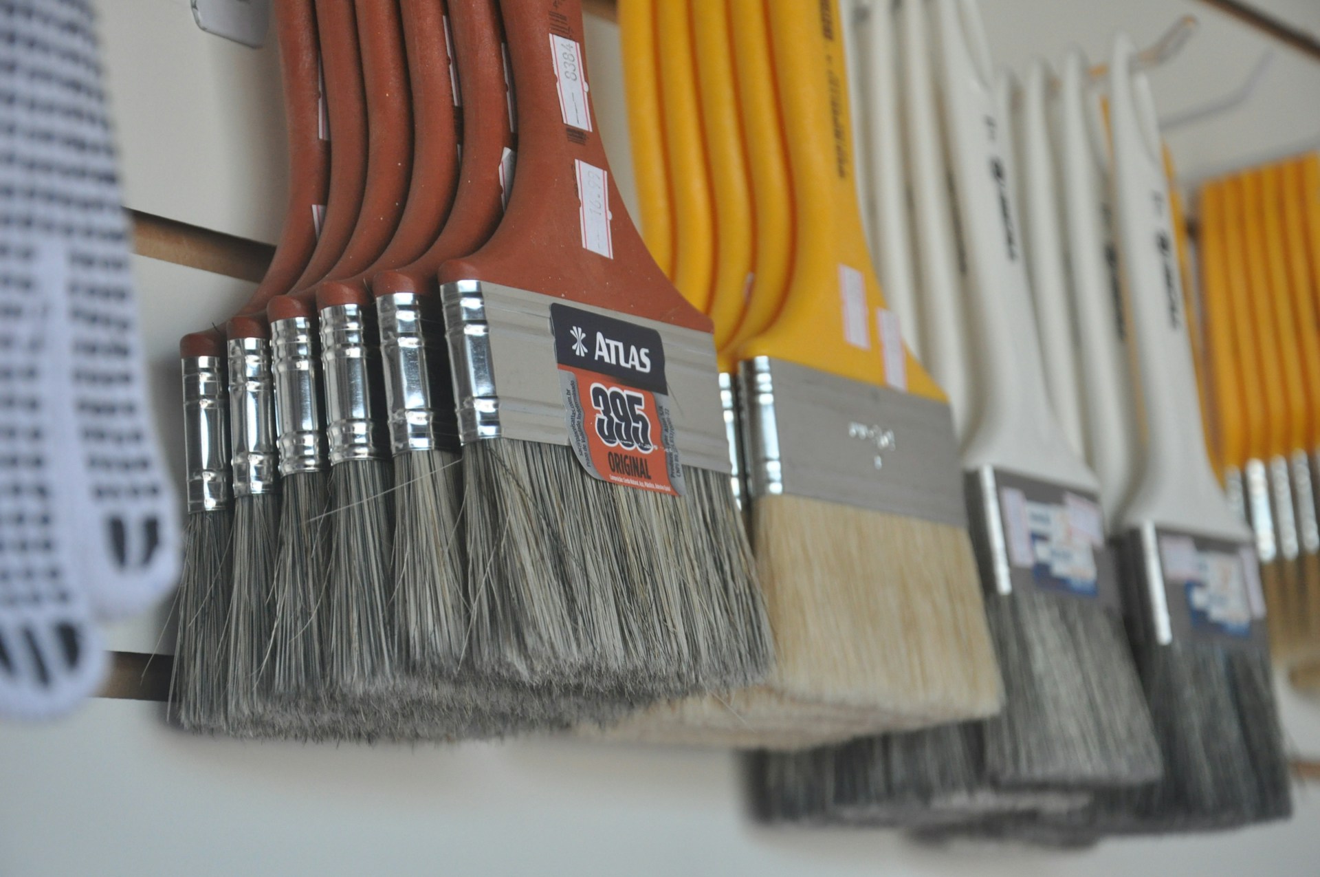 A set of multi-purpose cleaning brushes arranged neatly on a kitchen counter, showing various sizes and bristle types for different tasks.