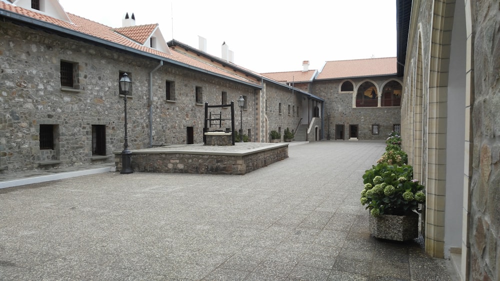 a courtyard with a bench and a potted plant