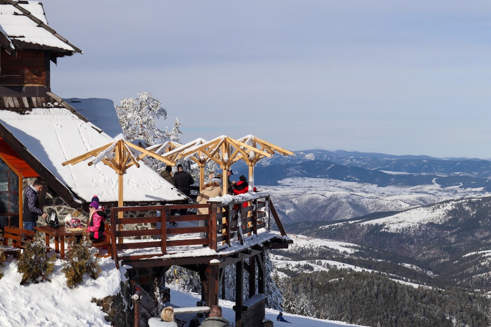 a group of people standing on top of a snow covered slope