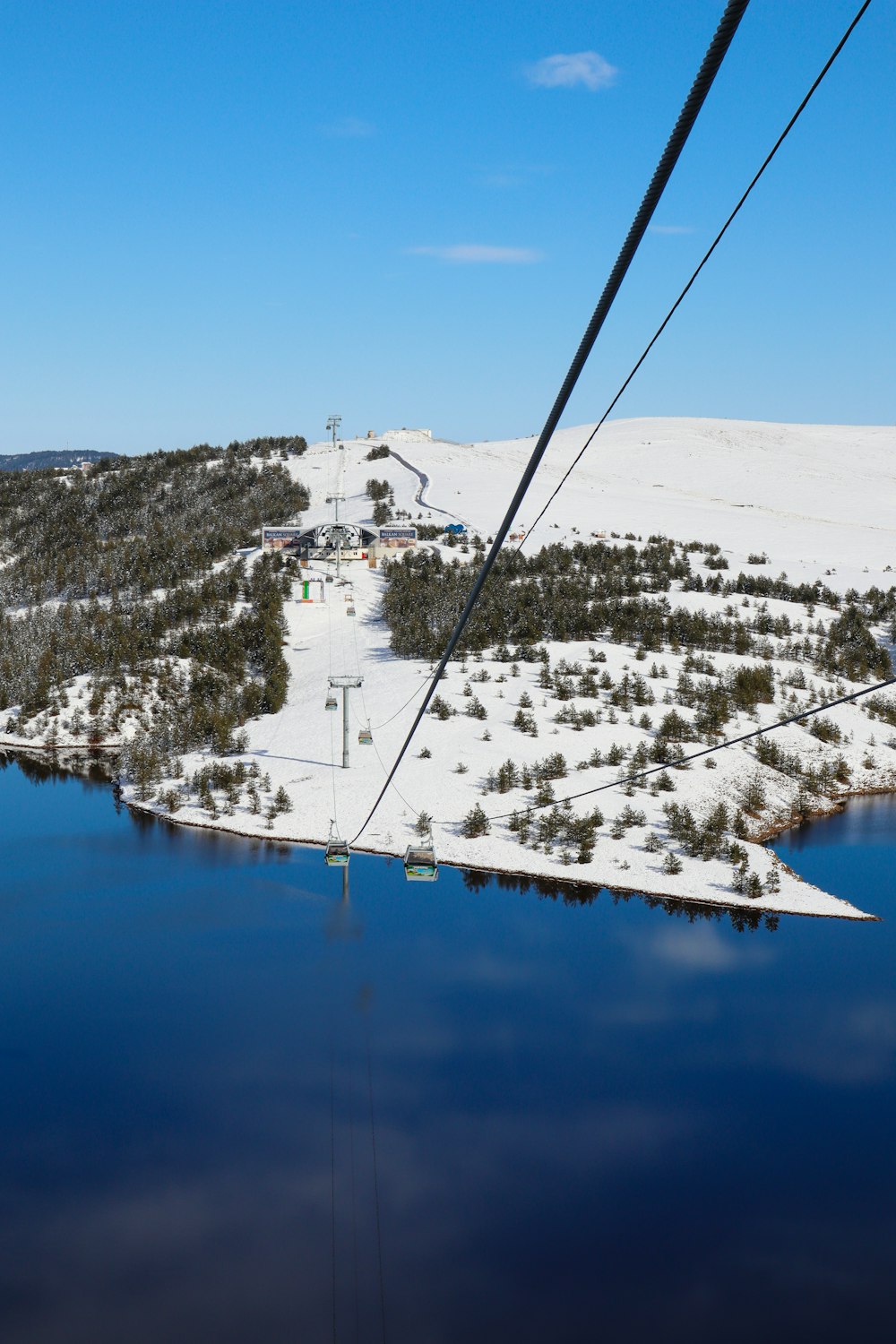 an aerial view of a ski resort and lake