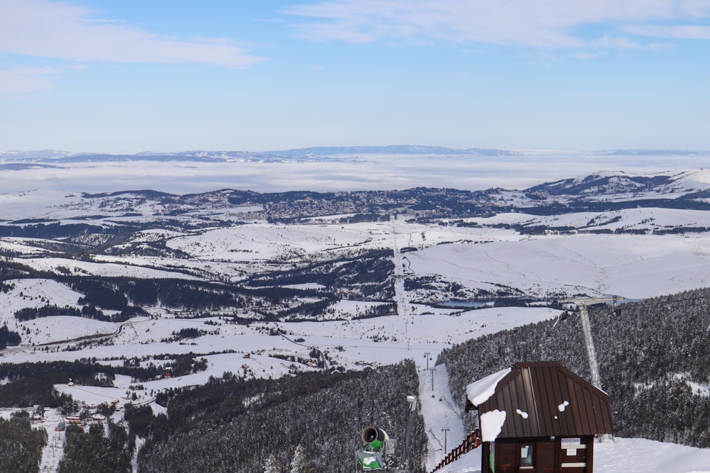 a person standing on top of a snow covered slope