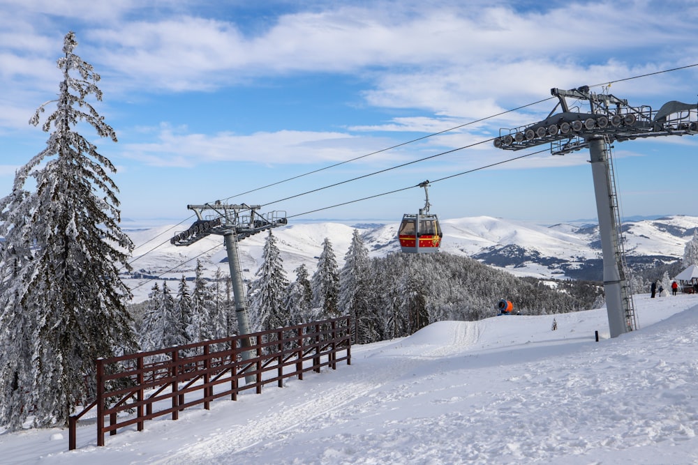 a ski lift going up a snowy mountain