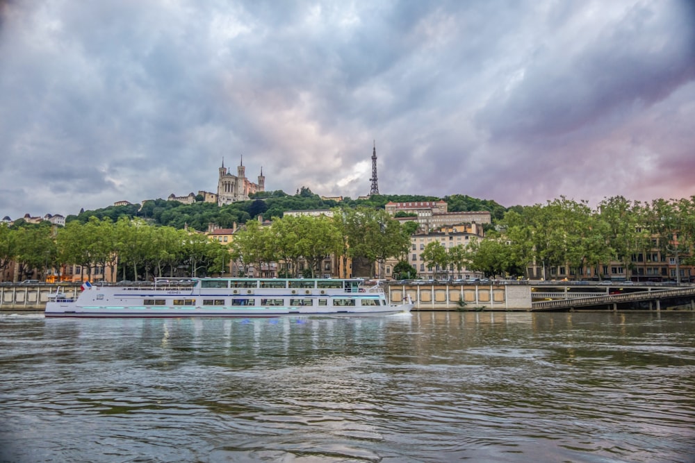 a river boat on a river with a city in the background