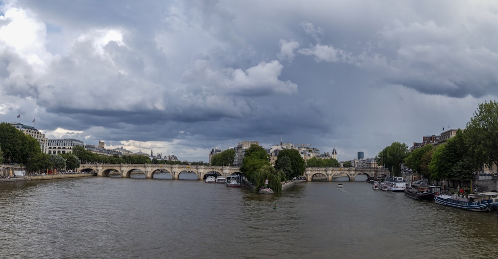 a view of a river with a bridge in the background