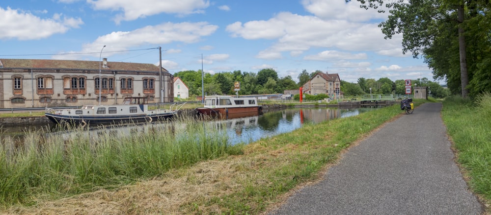 a narrow path next to a body of water