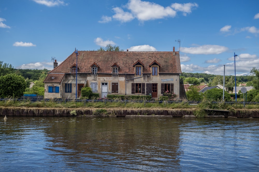 a house sitting next to a body of water