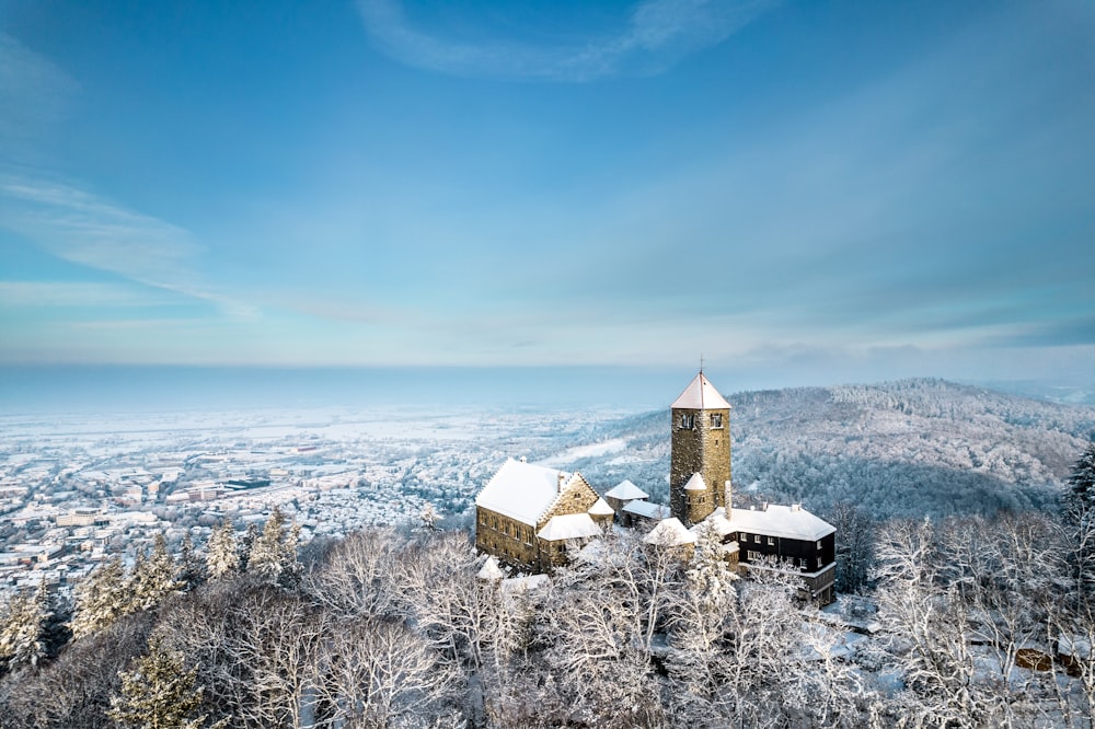 a snowy landscape with a church on top of a hill