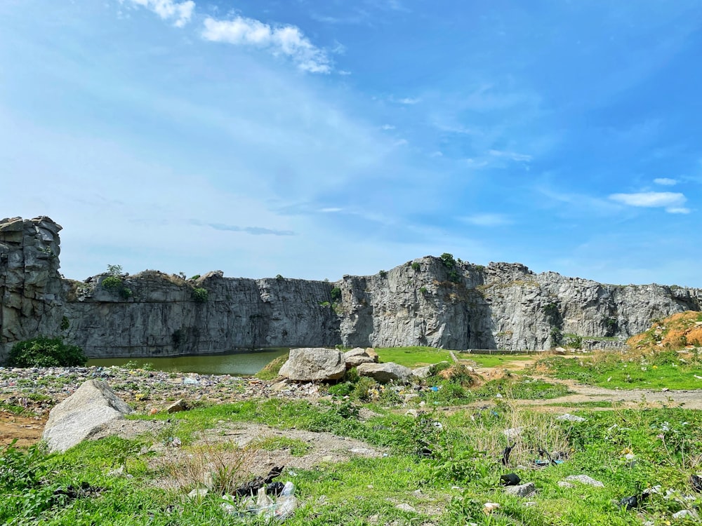 a large rock formation with a body of water in the middle of it