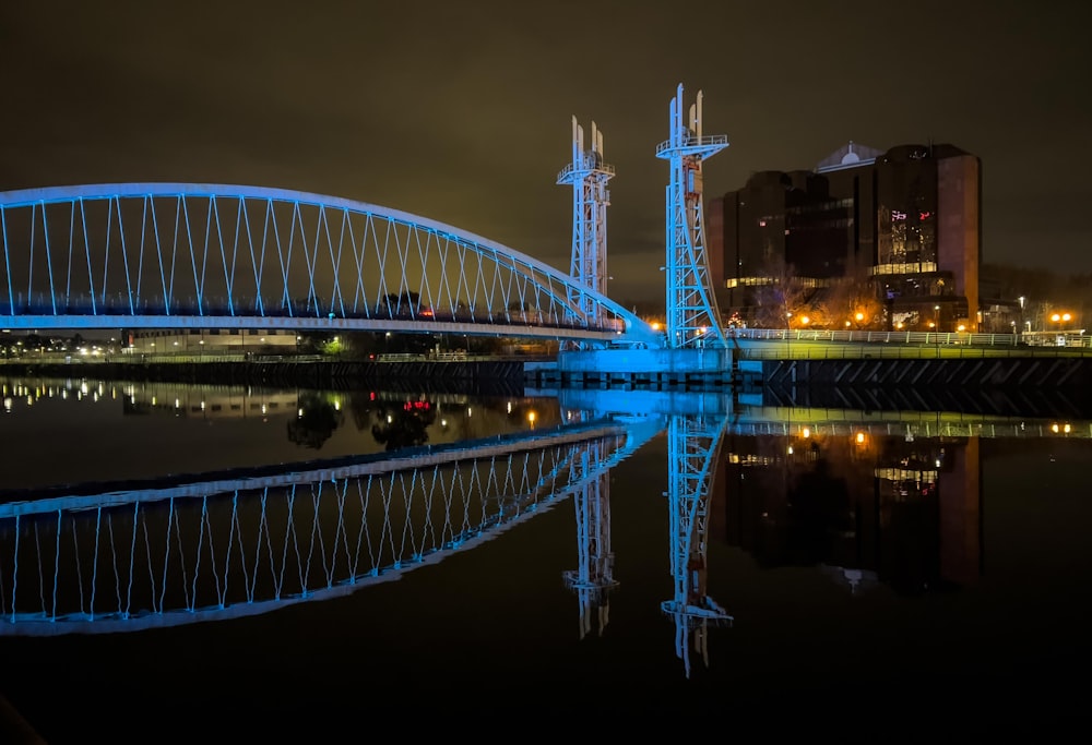 a large bridge over a body of water at night