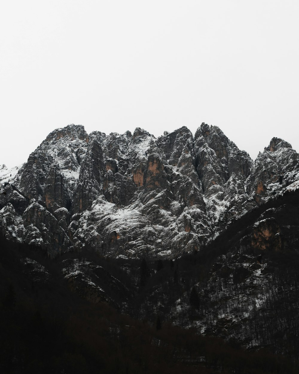 a mountain covered in snow with a sky background