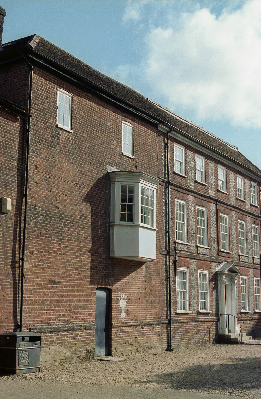 an old brick building with a window and shutters