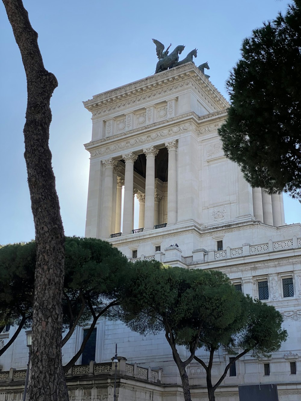 a large white building with a statue on top of it