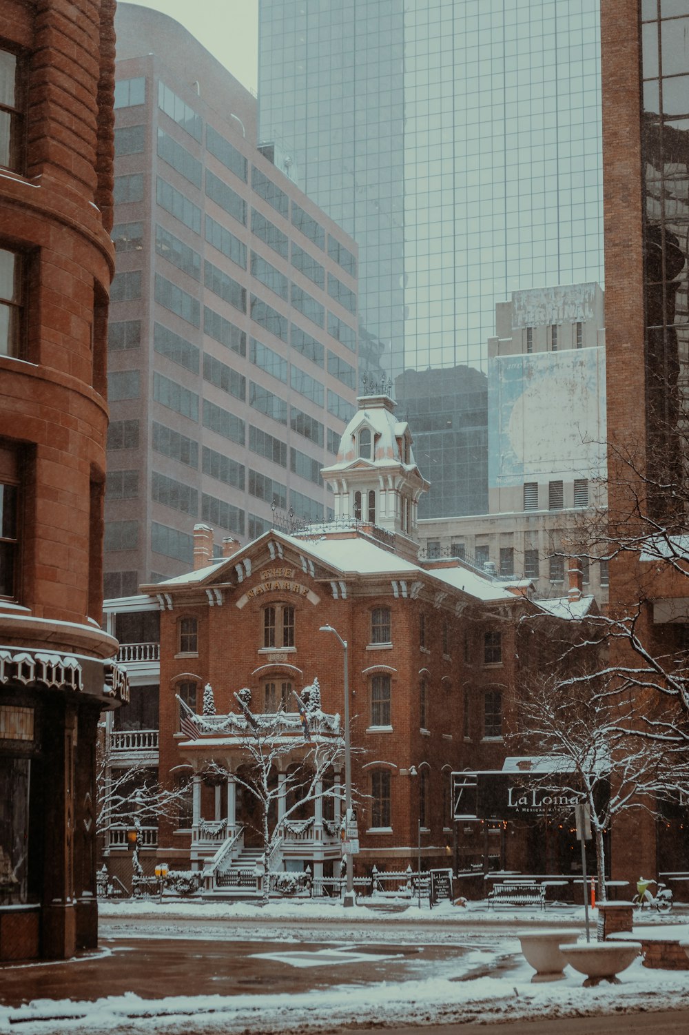 a building with a clock tower in the middle of a city