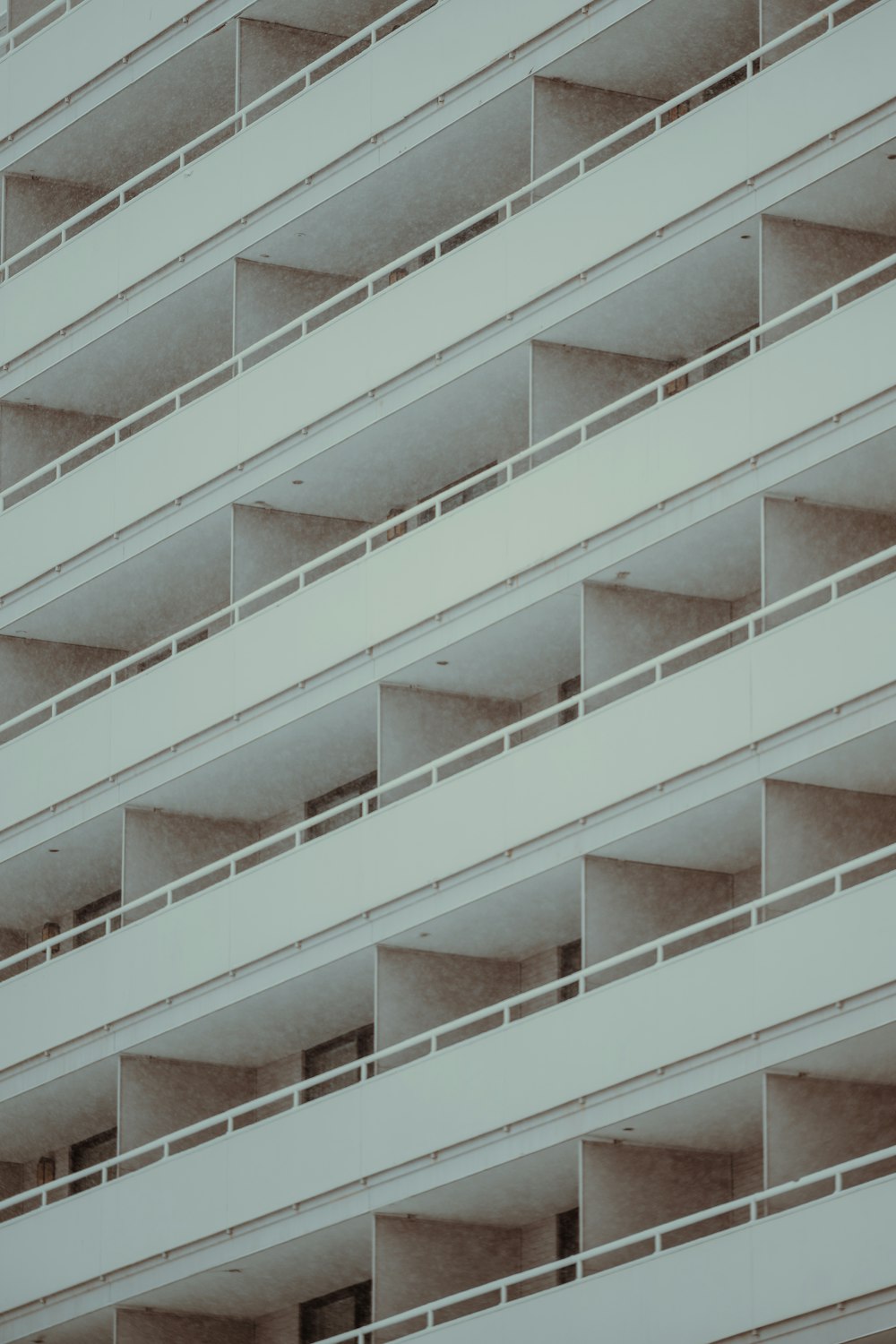 a tall white building with balconies and balconies