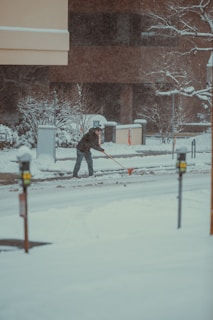 a man walking down a snow covered street