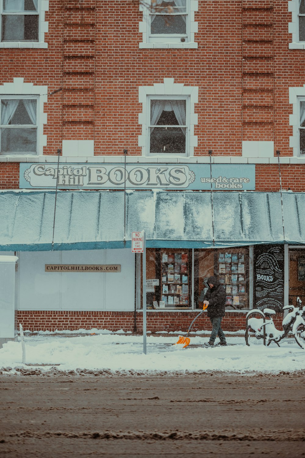 a person walking a dog in front of a book store