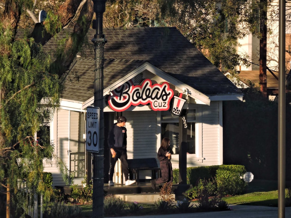 a couple of people standing outside of a building