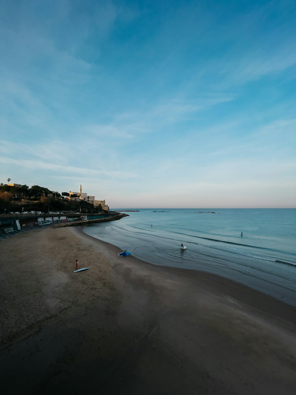 a view of a beach with people in the water