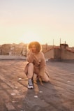 An urban rooftop scene at sunset featuring a model wearing Lumina Apparel's versatile joggers and accessories.