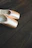 Close-up of shiny, elegant dance shoes on a polished wooden floor with gentle spotlight.