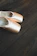 Close-up of delicate pink ballet shoes resting on a soft wooden floor.
