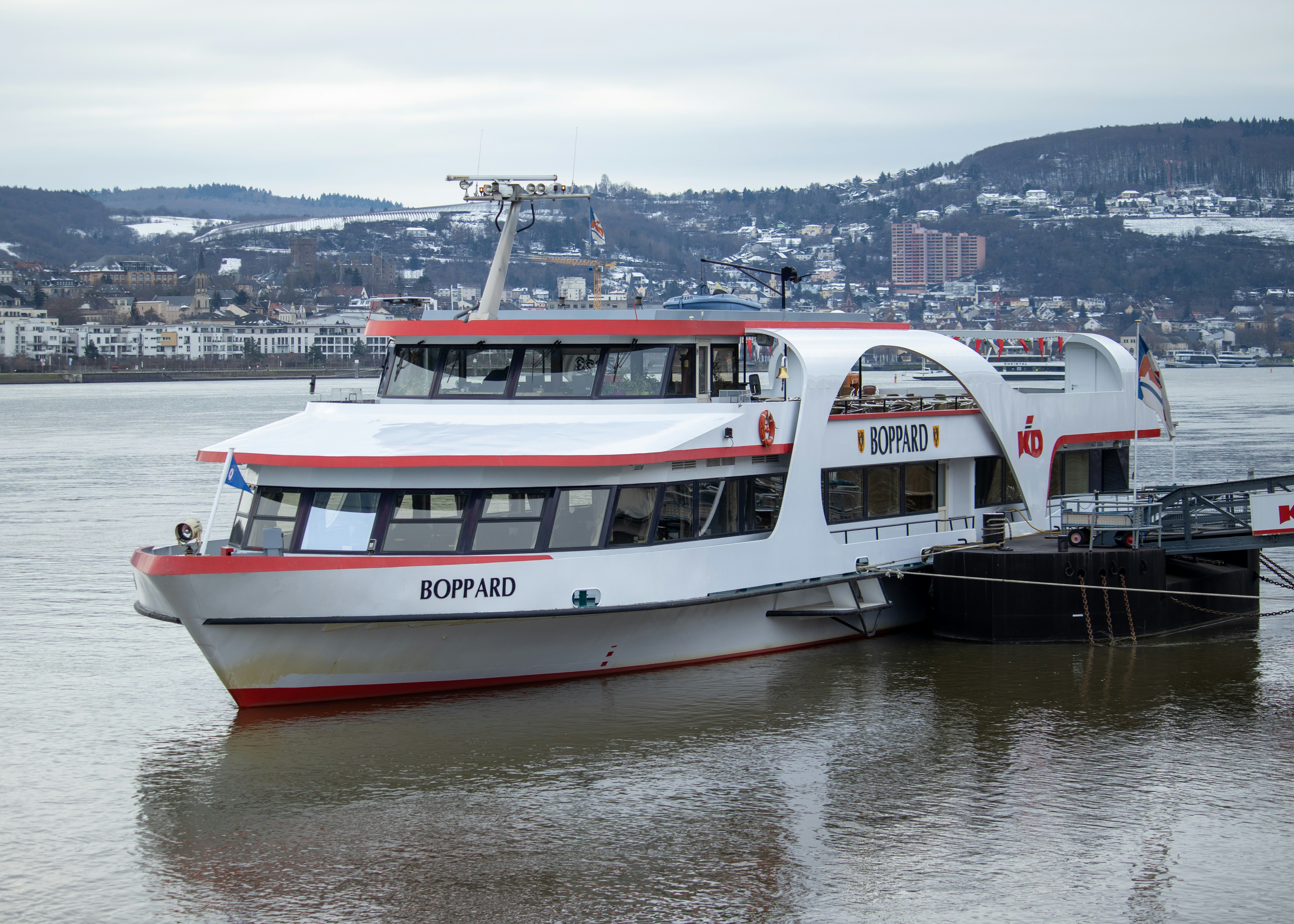 A large white and red boat in a body of water