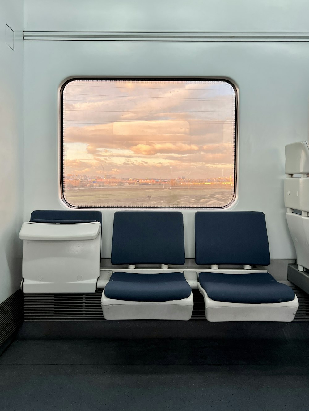 a seat on a train with a view of the sky
